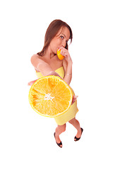 Image showing happy model eating an orange