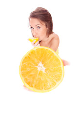 Image showing happy model eating an orange
