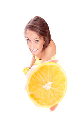 Image showing happy model eating an orange