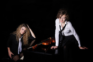 Image showing Two beautiful young women with violon and piano