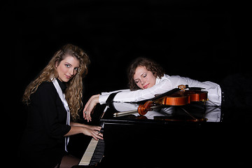 Image showing Two beautiful young women with violon and piano