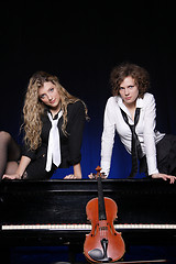 Image showing Two beautiful young women with violon and piano