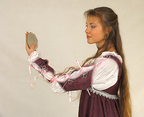 Image showing Young girl looking into the glass