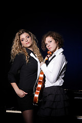 Image showing Two beautiful young women with violon and piano