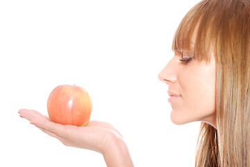 Image showing A pretty young woman holding an apple 