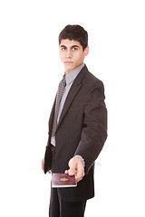 Image showing  A businessman in a suit holds passport