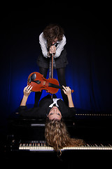 Image showing Two beautiful young women with violon and piano