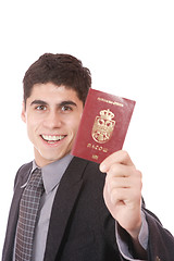 Image showing  A businessman in a suit holds passport