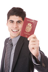 Image showing  A businessman in a suit holds passport