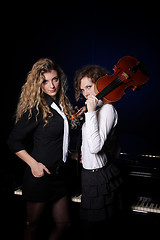 Image showing Two beautiful young women with violon and piano