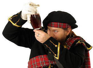 Image showing Scottish warrior with the bottle of red wine