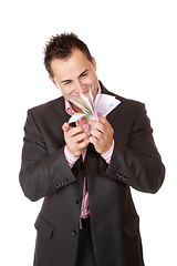 Image showing Portrait of a business man holding money 