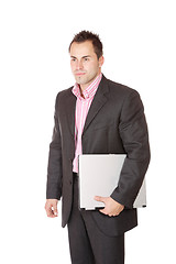 Image showing Happy businessman holding laptop computer