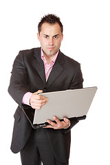 Image showing Happy businessman holding laptop computer