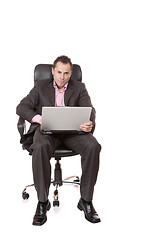 Image showing Relaxed young businessman, sitting on a chair.