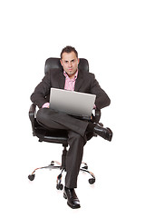 Image showing Relaxed young businessman, sitting on a chair.