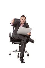 Image showing Relaxed young businessman, sitting on a chair.