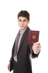 Image showing  A businessman in a suit holds passport