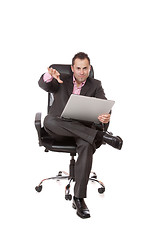 Image showing Relaxed young businessman, sitting on a chair.