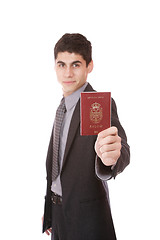 Image showing  A businessman in a suit holds passport