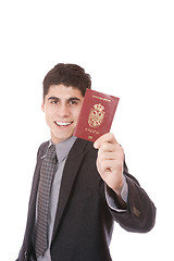 Image showing  A businessman in a suit holds passport