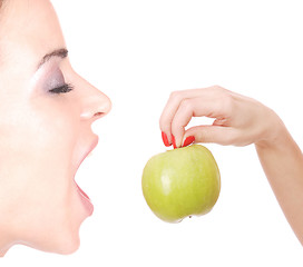 Image showing A pretty young woman holding an apple 