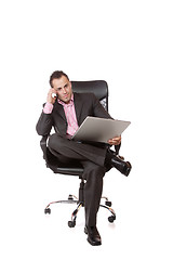 Image showing Relaxed young businessman, sitting on a chair.