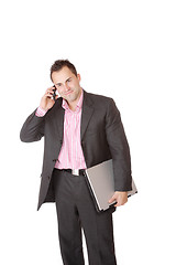 Image showing Happy businessman holding laptop computer