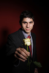 Image showing  Young happy smiling handsome man with rose