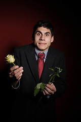 Image showing  Young happy smiling handsome man with rose