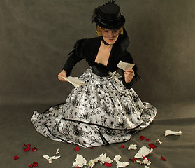 Image showing Lady  reading thescrap of letter