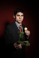 Image showing  Young happy smiling handsome man with rose