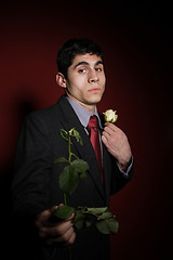 Image showing  Young happy smiling handsome man with rose