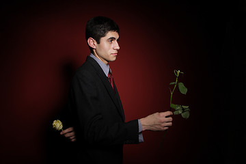 Image showing  Young happy smiling handsome man with rose