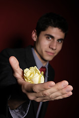 Image showing  Young happy smiling handsome man with rose