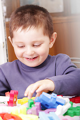 Image showing Smiling boy playing with toy blocks