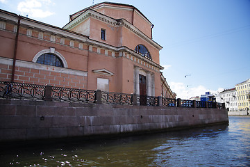 Image showing Old red building corner alongside channel