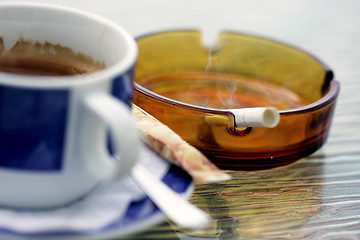 Image showing Smoking cigarette and cup of coffee