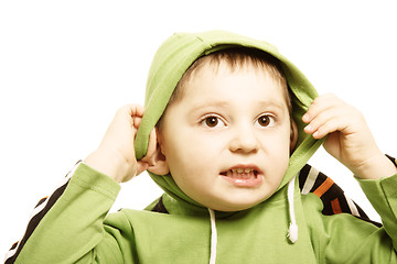 Image showing Boy in green putting on hood