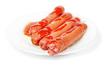 Image showing Sausages dressed with ketchup