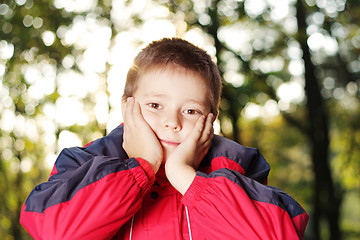 Image showing Boy in forest hands at face