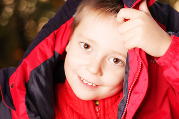 Image showing Boy trying put jacket on head