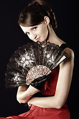 Image showing Young woman and fan