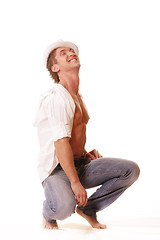 Image showing Guy in hat squating