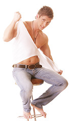 Image showing Guy on chair tearing shirt