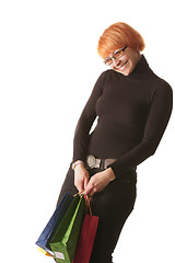 Image showing Smiling redhead with color bags