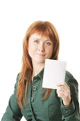 Image showing Redhead showing notepad 
