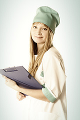 Image showing Smiling blonde doctor with folder