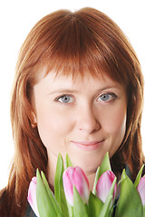 Image showing Serene redhead with pink tulips