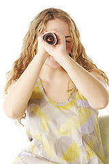 Image showing Woman looks through scrolled paper